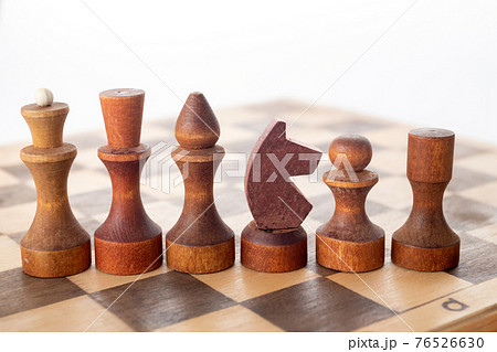 Chess pieces on wooden board for play 76526630