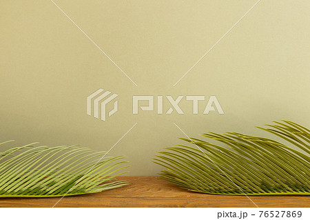 Tropical dry leaf on wooden table. khaki beige background 76527869