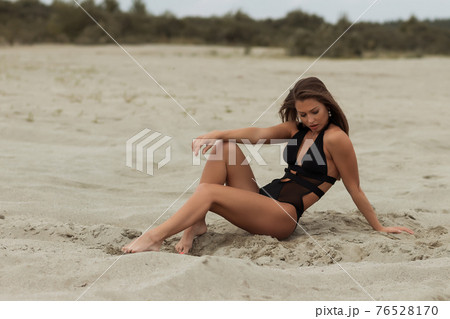 Gorgeous young female crawling on beach Gorgeous young female crawling on beach 76528170