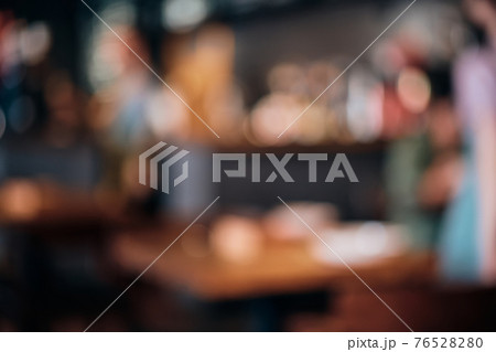Coffee shop blur background with bokeh lights. Blurred outlines of bar and tables, dim lights Coffee shop blur background with bokeh lights. Blurred outlines of bar and tables, dim lights 76528280