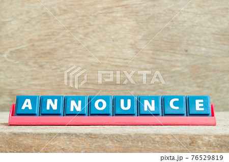 Tile alphabet letter with word announce in red color rack on wood background 76529819