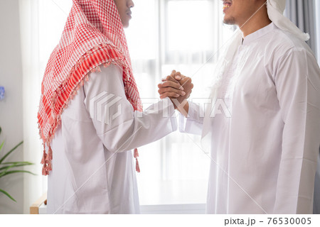 close up business muslim partner shaking hand 76530005