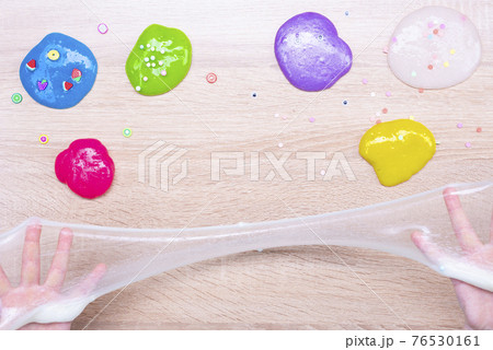 Multi-colored slimes on the table. The child plays with slimes. Play toy - slime Multi-colored slimes on the table. The child plays with slimes. Play toy - slime 76530161
