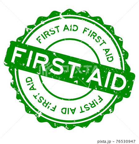 Grunge green first aid word round rubber seal stamp on white background 76530947