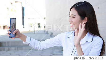 Asiian businesswoman has video chat 76531094