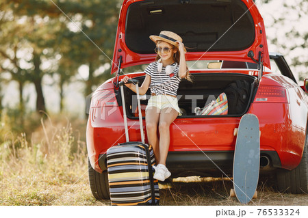 Child sitting in a car trunk 76533324