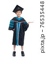 Cute Asian child in graduation gown show something copy space.Commercial advertisement. Promotion concept. Promoting product for kids. 76535448