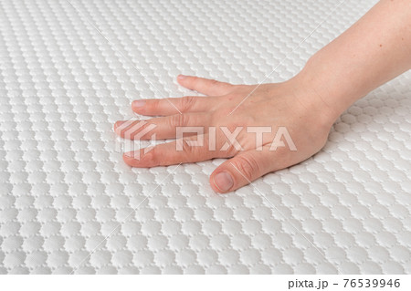 Woman is choosing new mattress for good sleeping 76539946