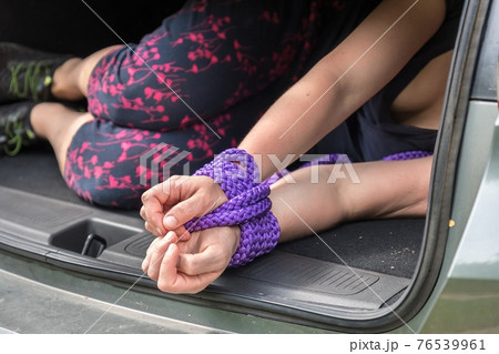 Woman with tied hands inside car trunk - kidnapping Woman with tied hands inside car trunk - kidnapping 76539961