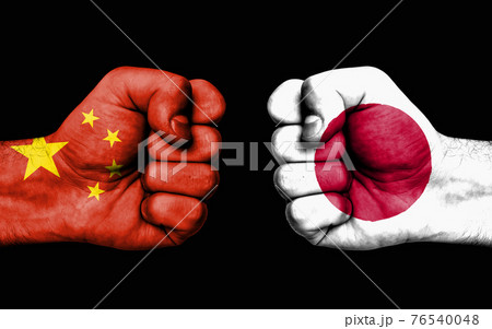 Conflict between China and Japan - male fists 76540048