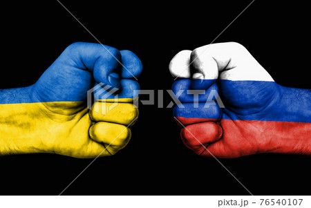 Conflict between Ukraine and Russia - male fists 76540107