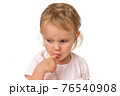 Little baby with finger inside mouth 76540908
