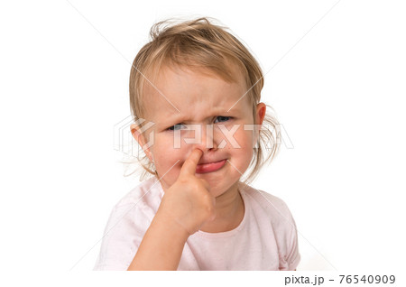 Sad baby girl is picking her nose with finger inside Sad baby girl is picking her nose with finger inside 76540909