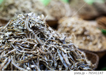 A lot of dried salted smelt at street market. Outdoors Food marketplace. Closeup 76541147