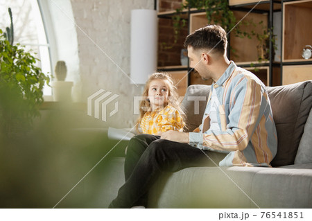 Happy father and little cute daughter at home. Family time, togehterness, parenting and happy childhood concept. Weekend with sincere emotions. Happy father and little cute daughter at home. Family time, togehterness, parenting and happy childhood concept. Weekend with sincere emotions. 76541851
