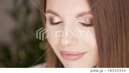 Beauty woman face with green eyes looking at camera. Skin care treatment or cosmetic ads concept. Beautiful female model with perfect fresh and clean skin. Nude make-up. In studio. Beauty woman face with green eyes looking at camera. Skin care treatment or cosmetic ads concept. Beautiful female model with perfect fresh and clean skin. Nude make-up. In studio. 76543354