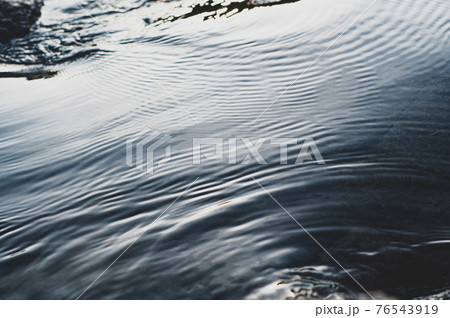 Fast flowing cold water mountain stream, flowing stream stream with flat smooth surface, nature outdoors, fresh stream dark blue 76543919