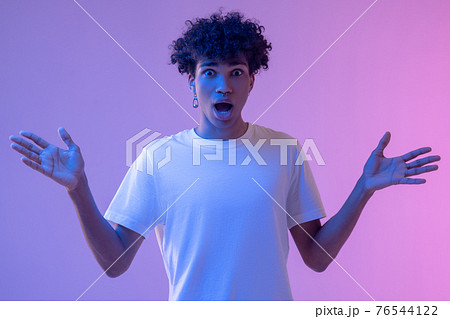 African american guy with curly hair looking surprised African american guy with curly hair looking surprised 76544122