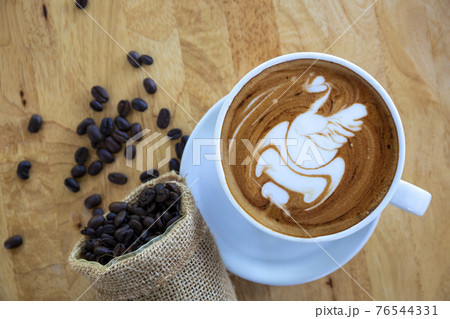 Art Coffee in White Cup on wood table in coffee shop. Art Coffee in White Cup on wood table in coffee shop. 76544331