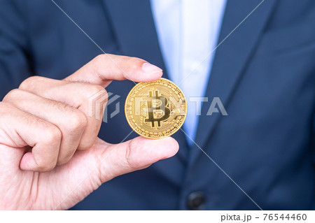 Businessman hand holding golden Bitcoin (BTC) cryptocurrency, Crypto is Digital Money within the blockchain network, is exchanged using technology and online internet exchange. Financial concept Businessman hand holding golden Bitcoin (BTC) cryptocurrency, Crypto is Digital Money within the blockchain network, is exchanged using technology and online internet exchange. Financial concept 76544460