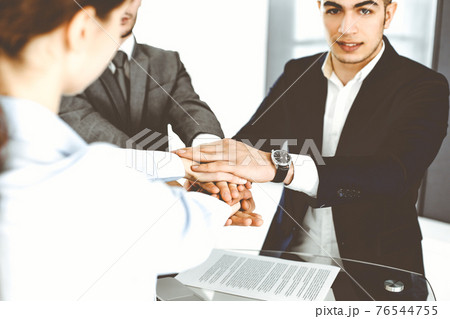 Business people group showing teamwork and joining hands as a circle in modern office. Success concept Business people group showing teamwork and joining hands as a circle in modern office. Success concept 76544755
