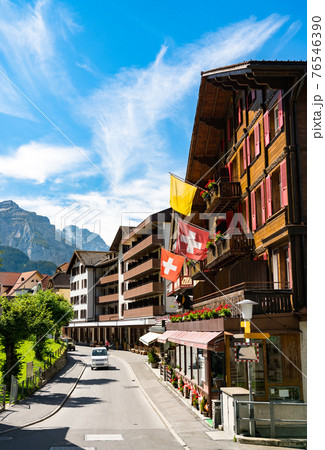 Main street of Wengen with Swiss Flags in Switzerland 76546390