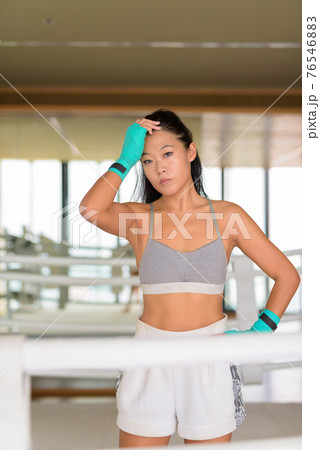 Asian woman kick boxer ready for exercise at gym boxing ring Asian woman kick boxer ready for exercise at gym boxing ring 76546883