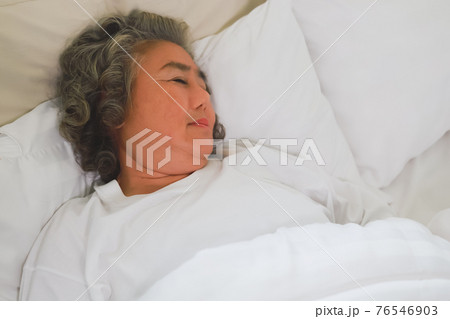 Asian Elderly woman sleep and sweet dream on bed. Asian Elderly woman sleep and sweet dream on bed. 76546903