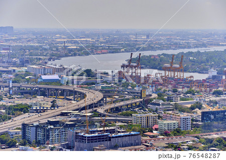 Bangkok, Thailand - 8 March 2019: Bird's eye view to show the beautiful sky and heavy traffic above the city view of Bangkok that is full of harmful PM2.5 dust that is harmful to the body.soft focus. Bangkok, Thailand - 8 March 2019: Bird's eye view to show the beautiful sky and heavy traffic above the city view of Bangkok that is full of harmful PM2.5 dust that is harmful to the body.soft focus. 76548287