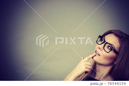 Closeup of woman thinking face expression 76549159