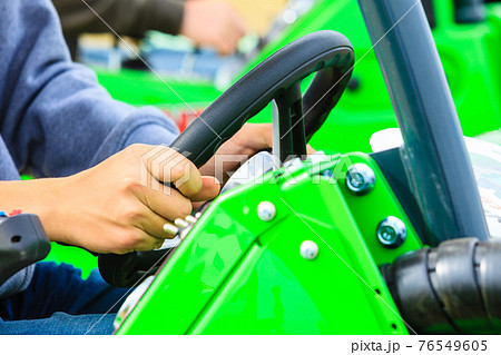 Man operating big industrial agricultural machine Man operating big industrial agricultural machine 76549605