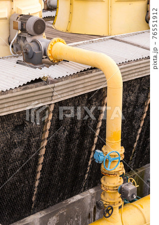 Pipes and valves of industrial air conditioner on high building. Pipes and valves of industrial air conditioner on high building. 76551912
