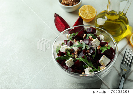 Concept of tasty eating with beet salad on white textured background 76552103