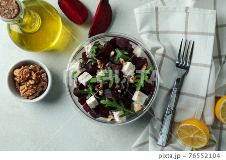 Concept of tasty eating with beet salad on white textured background 76552104