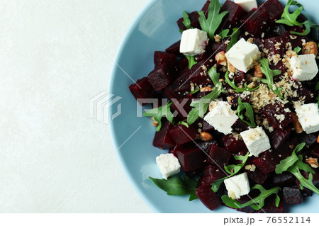 Concept of tasty eating with beet salad on white textured table Concept of tasty eating with beet salad on white textured table 76552114