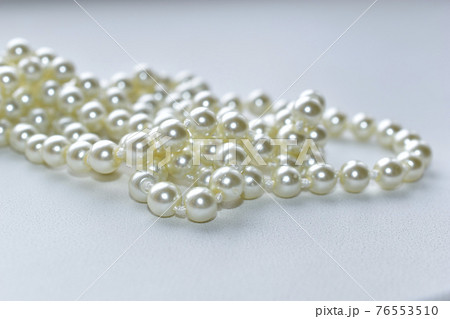Yellow beautiful beads necklace on white background Yellow beautiful beads necklace on white background 76553510
