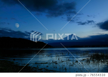Cloud around mount Fuji with moon after sunset during winter season 76554310