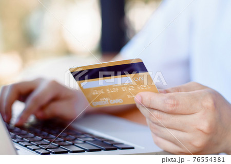 Online Payment . Woman hands holding credit card and using laptop. Online shopping 76554381