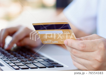 Online Payment . Woman hands holding credit card and using laptop. Online shopping 76554383
