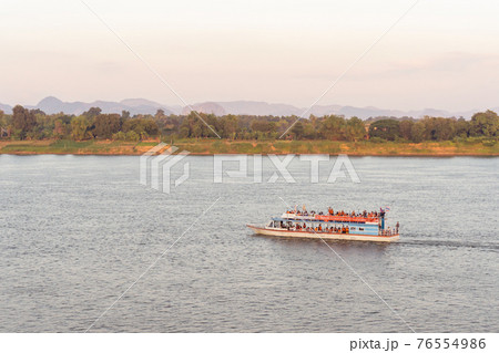 NAKHON PHANOM, THAILAND - NOV 27, 2020 : Tourist boat in Mekong river Nakhon phanom Thailand to Lao 76554986