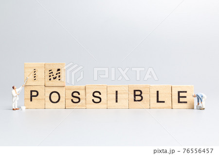 Miniature people worker team on impossible word in wooden alphabet letters Miniature people worker team on impossible word in wooden alphabet letters 76556457