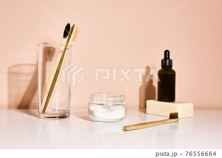 Bamboo toothbrushes with toothpaste on pink background 76556664