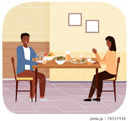 People at lunch with healthy nutrition dishes. Man and woman have dinner with salad and sandwiches. 76557436