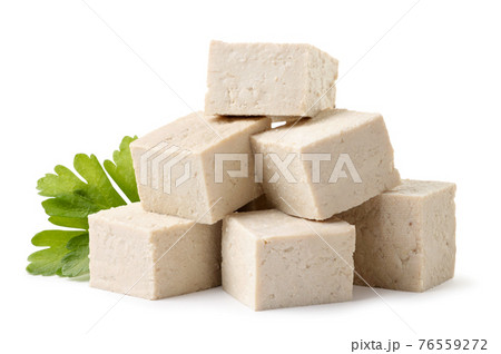 Heap of diced tofu cheese with parsley on a white background. Isolated Heap of diced tofu cheese with parsley on a white background. Isolated 76559272
