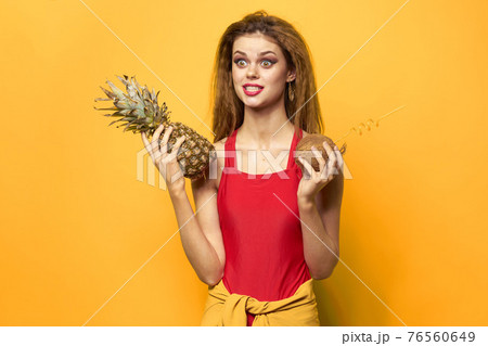 woman with pineapple and coconut cocktail exotic fruits summer lifestyle yellow background woman with pineapple and coconut cocktail exotic fruits summer lifestyle yellow background 76560649