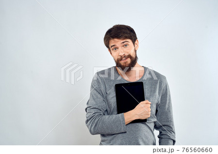emotional man holding tablet technology communication internet work light background emotional man holding tablet technology communication internet work light background 76560660