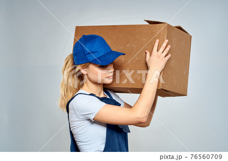 Woman in working uniform box packing service lifestyle Woman in working uniform box packing service lifestyle 76560709