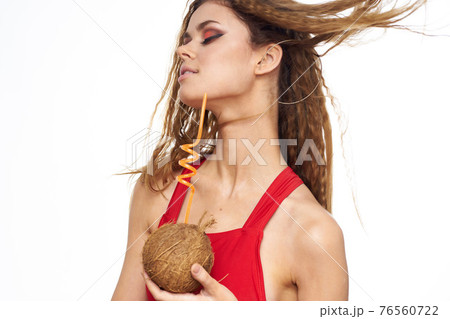Cheerful woman coconut cocktail red swimsuit summer vacation lifestyle Cheerful woman coconut cocktail red swimsuit summer vacation lifestyle 76560722