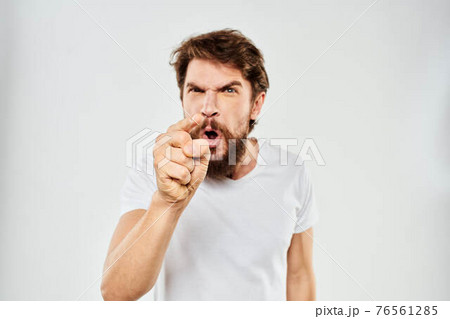 emotional man with a beard gesturing with his hands close-up studio aggression 76561285