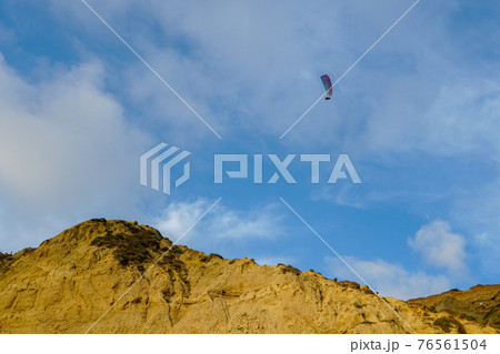 Man doing sport, Para-glider in the clouded sky. 76561504